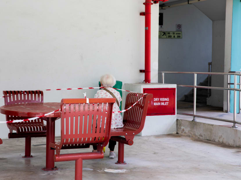 An elderly woman is seen sitting down, catching her breath at a void deck on April 29, 2020. An elderly woman is seen sitting down, catching her breath at a void deck on April 29, 2020.
