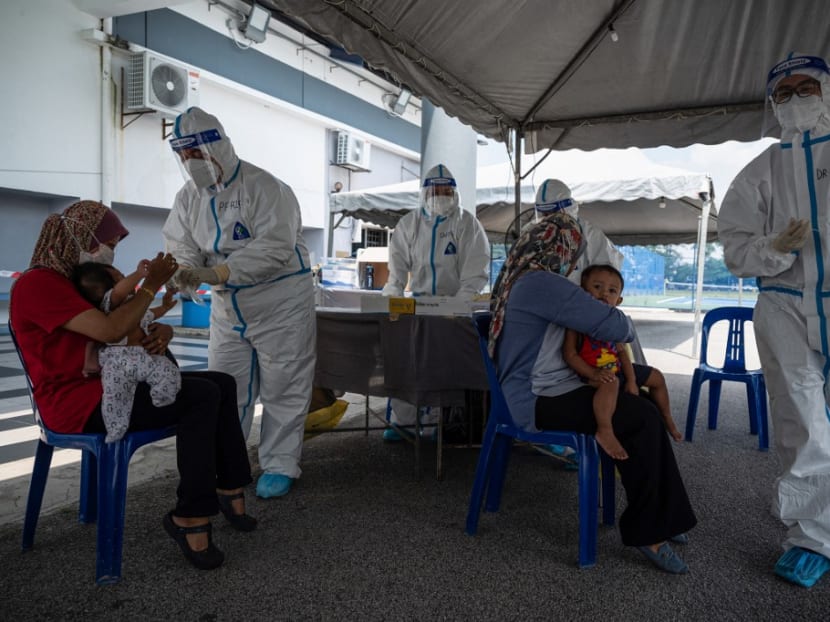 Medical personnel wearing protective suits conduct tests at a Covid-19 coronavirus testing site in Shah Alam, on the outskirts of Kuala Lumpur, on Feb 17, 2021.