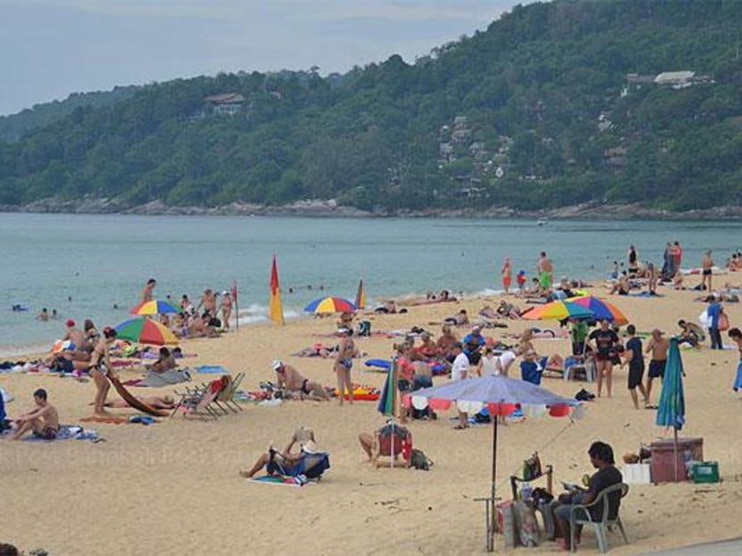 Foreign tourists relax on the beach in Phuket, a popular destination in southern Thailand.  Photo: Bangkok Post