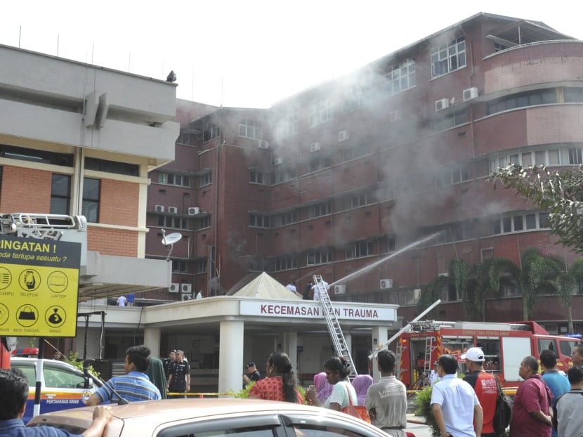 Fire fighters putting out fire which broke out on the second floor of the Hospital Sultanah Aminah in Johor Bahru on Tuesday. Photo: AP