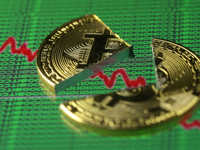 Broken representation of the Bitcoin virtual currency, placed on a monitor that displays stock graph and binary codes, are seen in this illustration picture. Bitcoin and other cryptocurrencies represent the mother of all bubbles, says the author. Photo: Reuters