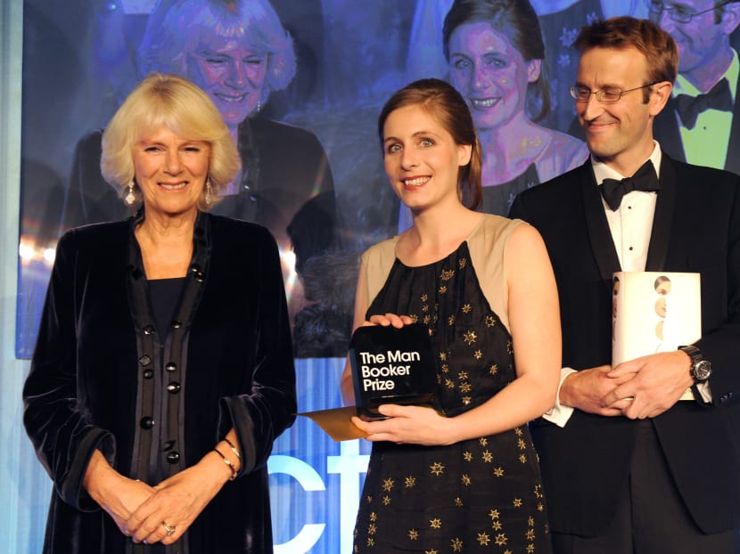 New Zealand author Eleanor Catton, center, holds her prize and stands with the Duchess of Cornwall and Robert Macfarlane, Chair of judges, after winning the Man Booker Prize for Fiction, in central London, Tuesday Oct 15, 2013.  Photo: AP
