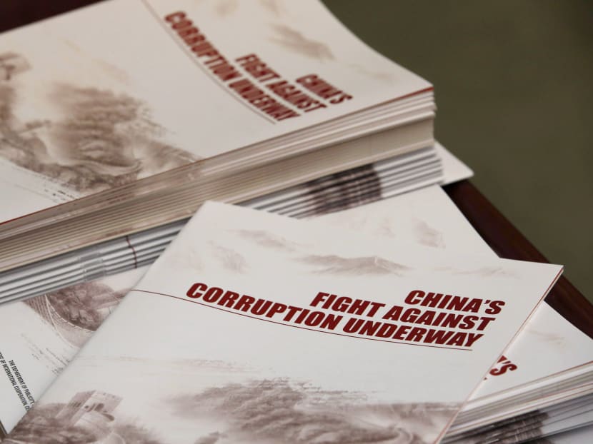 Copies of a anti-corruption booklet from China's anti-graft watchdog, Central Commission for Discipline Inspection. China plans to change its law to allow judgments to be delivered in corruption cases even when the suspects do not appear in court.