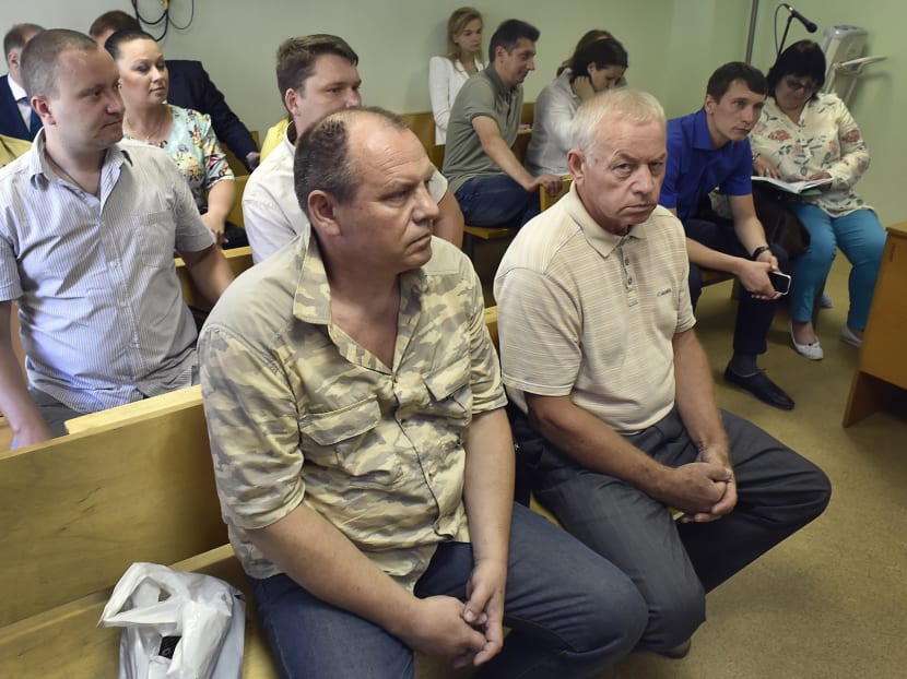 Former snowplough driver at Vnukovo airport Vladimir Martynenko (front R), head engineer of the Vnukovo airport service Vladimir Ledenev (front L) and Vnukovo airport's dispatcher Aleksandr Kruglov (C back) attend a hearing at Moscow's Solntsevsky district court on July 28, 2016. Photo: AFP