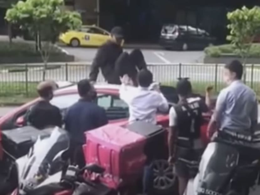 Muhammad Shafiee Abdul Hakim sitting on a taxi, in footage taken from a video of the incident posted online.