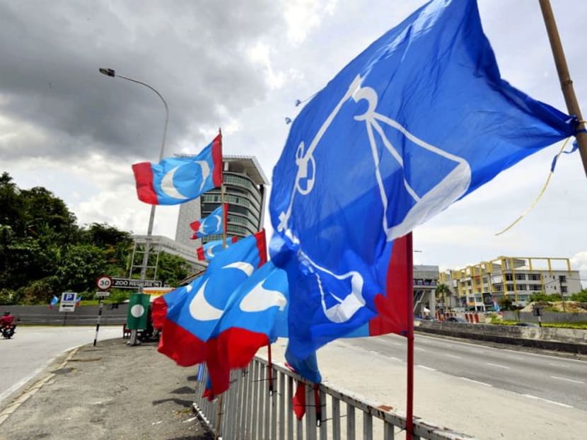Barisan Nasional and PKR flags are seen near a bus-stop along Jalan Ulu Klang, Kuala Lumpur on April 10.