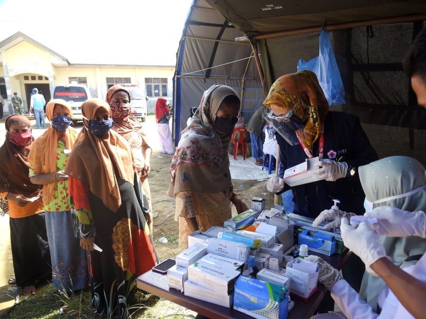 This picture taken on Sept 9, 2020 shows a group of Rohingya women queueing up for medical check-ups at a transit camp after nearly 300 Rohingya migrants came ashore on the beach in Lhokseumawe on the northern coast of Indonesia's Sumatra island. This picture taken on Sept 9, 2020 shows a group of Rohingya women queueing up for medical check-ups at a transit camp after nearly 300 Rohingya migrants came ashore on the beach in Lhokseumawe on the northern coast of Indonesia's Sumatra island.