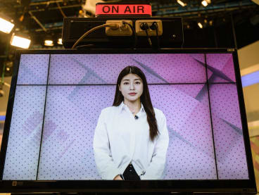 This photo taken in Seoul on April 17, 2023 shows Zaein, one of South Korea's most active virtual humans created by Artificial Intelligence company Pulse9, is seen on a screen for a live morning news programme on South Korean broadcaster SBS.