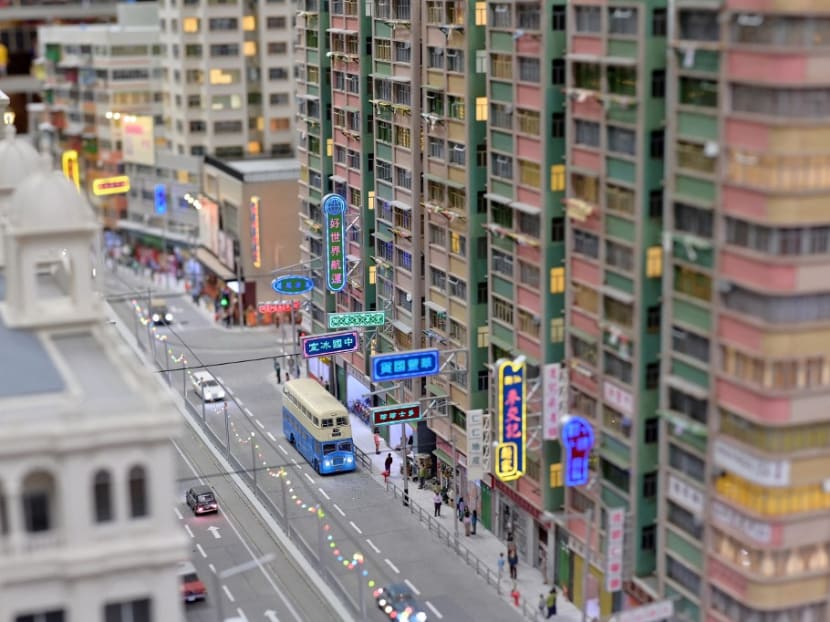 This photo taken on June 23, 2021 shows a recreation of a scene from old Hong Kong, created by model makers Ms Maggie Chan and Mr Tony Lai of Toma Miniatures, pictured at their studio in Hong Kong.