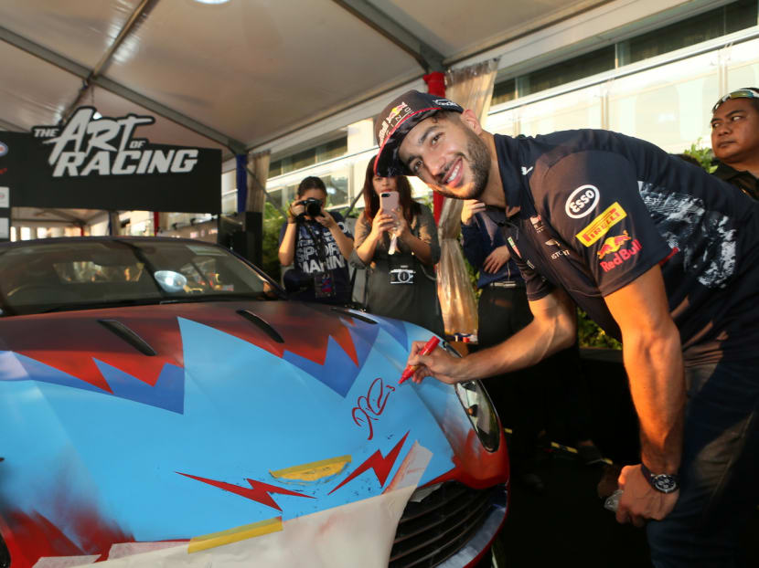 Daniel Ricciardo putting his finishing touch to an Aston Martin art car at the Marina Barrage yesterday. The Aussie has found victory in Singapore elusive so far. Photo: ExxonMobil Asia Pacific