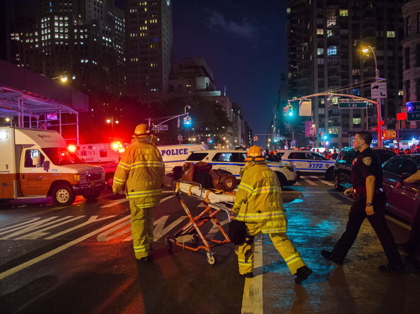 Police and firefighters near the scene of an explosion in New York which injured nearly 30 people on Saturday night. Photo: AP
