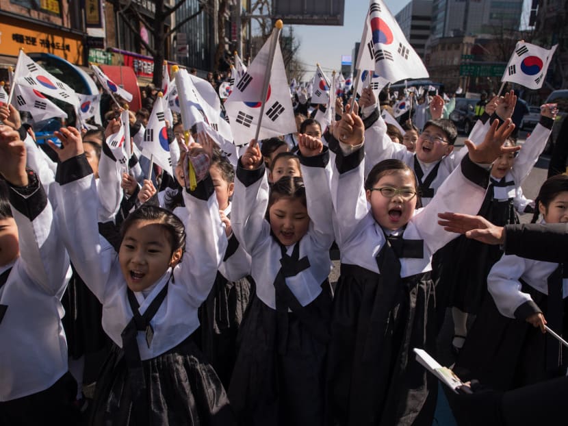 South Koreans  wearing traditional costumes. An education official was fired for calling "99 per cent of South Korean children 'dogs and pigs'". Photo: AFP