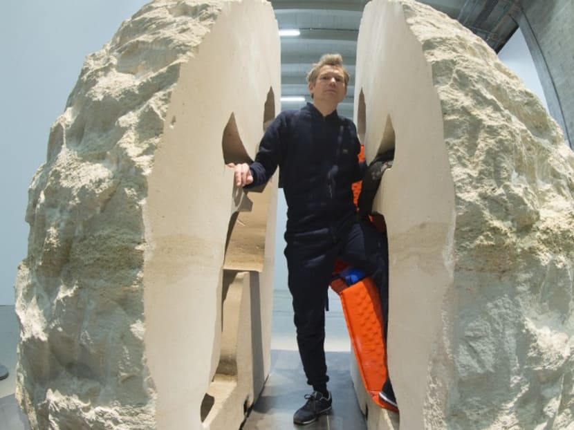French artist Abraham Poincheval with the rock he is currently entombed in. Photo: AFP