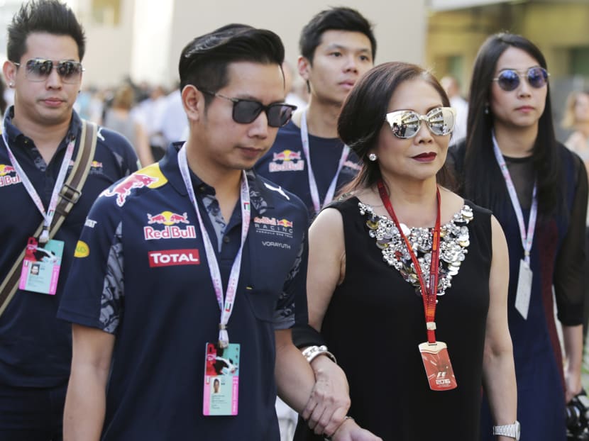 Vorayuth "Boss" Yoovidhya, second left, whose grandfather co-founded energy drink company Red Bull, walks with his mother Daranee, second right, at the Formula 1 Grand Prix in Abu Dhabi. Vorayuth is accused of killing a Thai police officer in a hit-and-run in 2012, yet he still has not appeared to face charges. Photo: XPB Images via AP