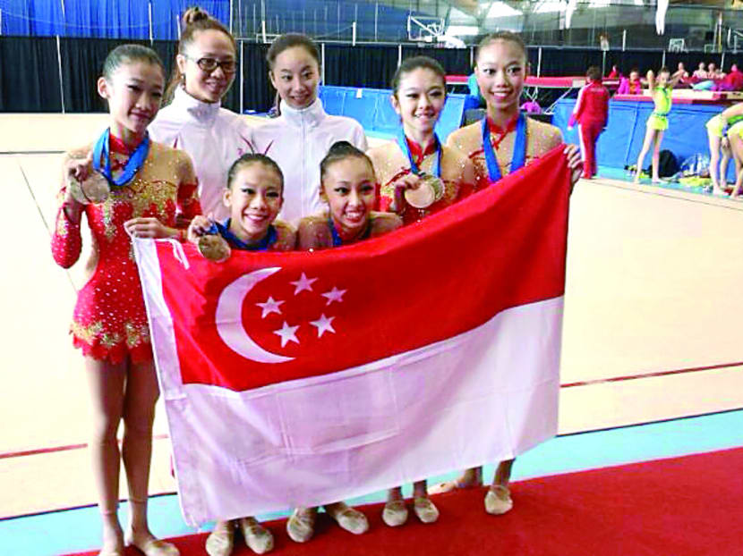 Singapore’s Under-15 junior team edged out powerhouses US (12.000) for silver in the Group Hoop with a score of 12.050. PHOTO: SINGAPORE GYMNASTICS