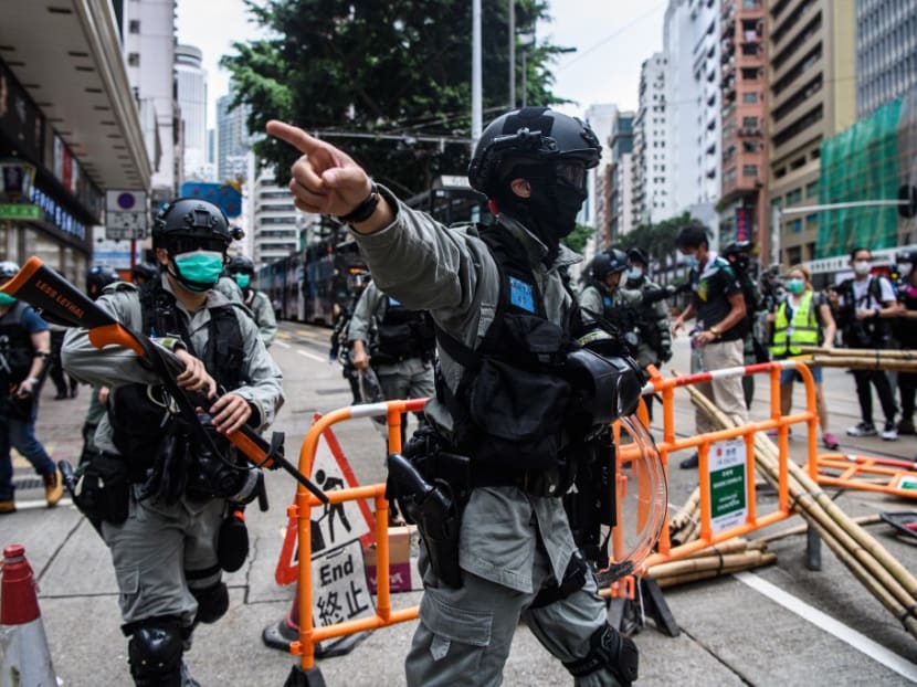 Riot police clear up debris left by protesters attending a pro-democracy rally against a proposed new security law in Hong Kong on May 24, 2020.