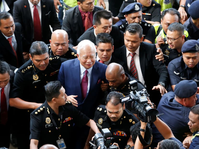 Ex-Malaysian prime minister Najib Razak arrives in court to be charged.