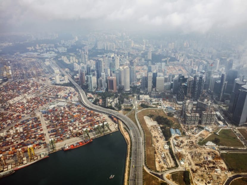 The Marina Coastal Expressway passes the Tanjong Pagar container terminal, front left, the Keppel container terminal, rear left, and buildings in the central business district in this aerial photograph taken above Singapore.