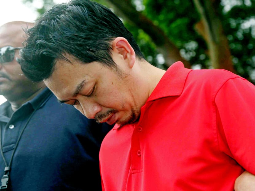 Lee Sze Yong, one of the 2 men accused of kidnapping Sheng Siong CEO Lim Hock Chee's elderly mother Ng Lye Poh, was taken by the police to Sembawang Park on 20 Jan 2014. TODAY file photo