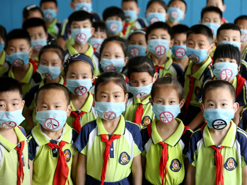 Photo: Primary school students wear masks with “No Smoking” sign during an event to promote the World No Tobacco Day on May 31, in Linyi, Shandong province, China, May 30, 2019.
