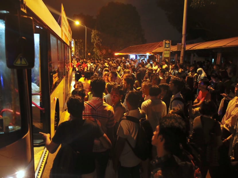 A crowd of commuters wait for free shuttle buses at the bus stop opposite Bishan MRT station after train services from Ang Mo Kio to Marina South Pier were suspended on Oct 7, 2017 due to a flooded train tunnel between Bishan and Braddell stations. Photo by Najeer Yusof/TODAY