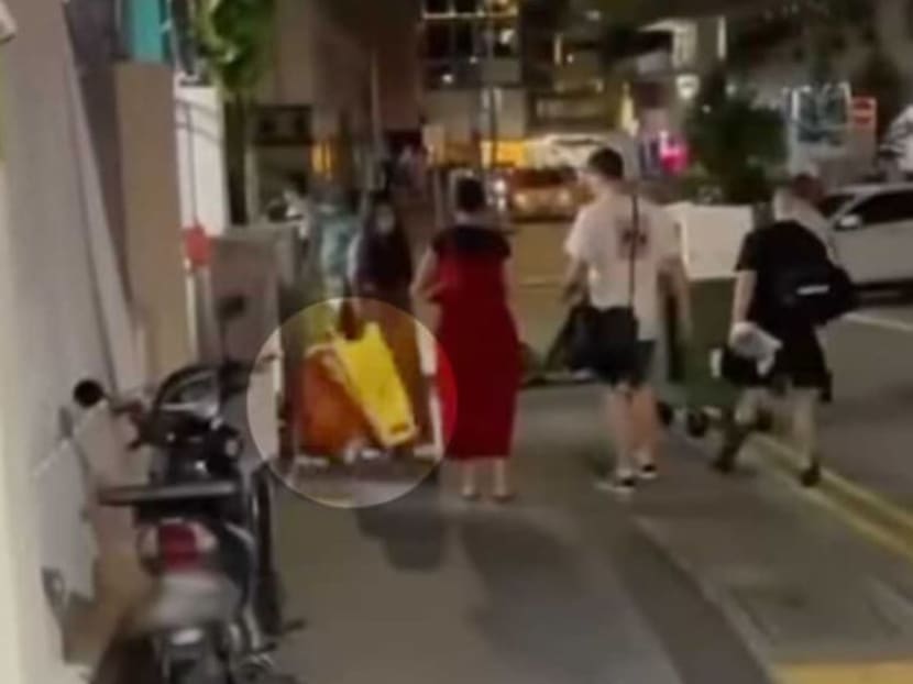A screengrab from a video circulating on social media showing an incident along Keong Saik Road where a child was hit by a signboard.