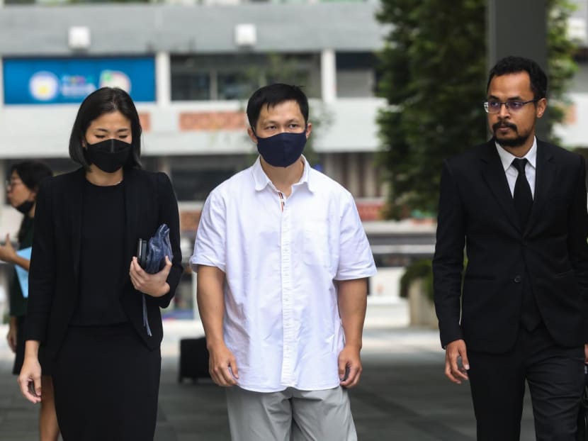 Karl Liew (centre) at the State Courts on April 14, 2023. The 45-year-old pleaded guilty to lying to the judge.