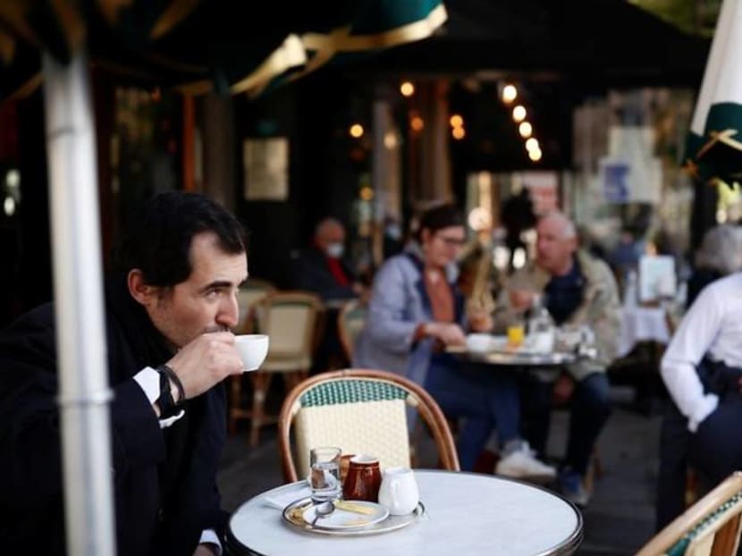 Parisians tuck into coffee and croissants again as cafes re-open Parisians tuck into coffee and croissants again as cafes re-open