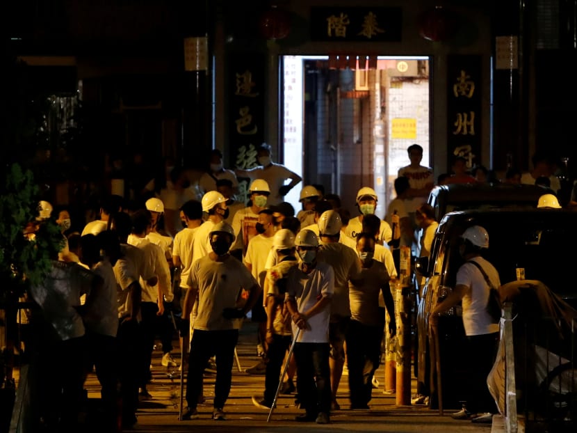Photo of the day: Men in white t-shirts and carrying poles are seen in Yuen Long after attacking anti-extradition bill demonstrators at a train station in Hong Kong, China, on Monday, July 22, 2019.