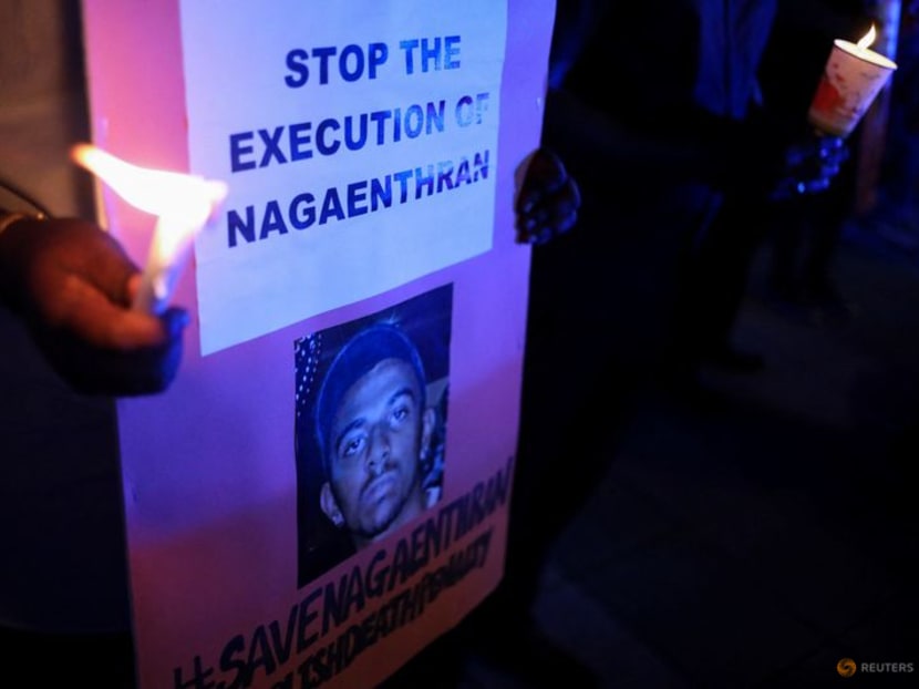 A demonstrator holds placards while taking part in a vigil ahead of the planned execution of Malaysian drug trafficker, Nagaenthran Dharmalingam, outside Singapore High Commission in Kuala Lumpur, Malaysia, April 26, 2022. REUTERS/Hasnoor Hussain