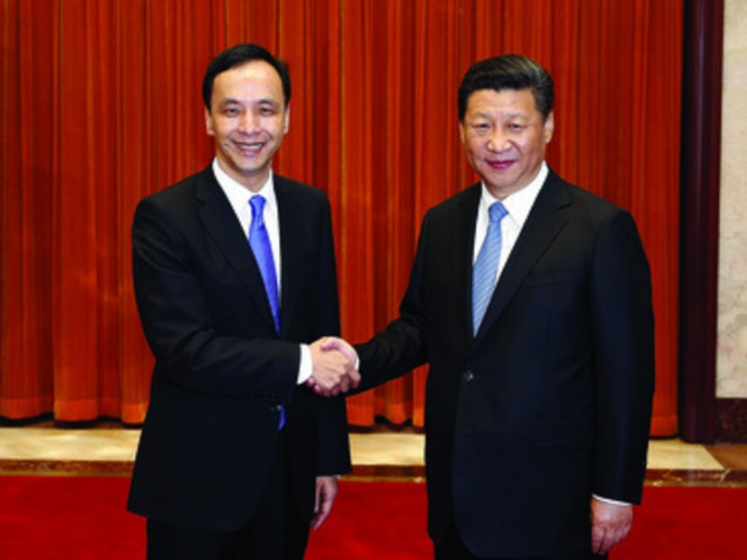 Mr Eric Chu, chairman of Taiwan’s ruling Kuomintang party, with Chinese President Xi Jinping in Beijing yesterday. Photo: REUTERS