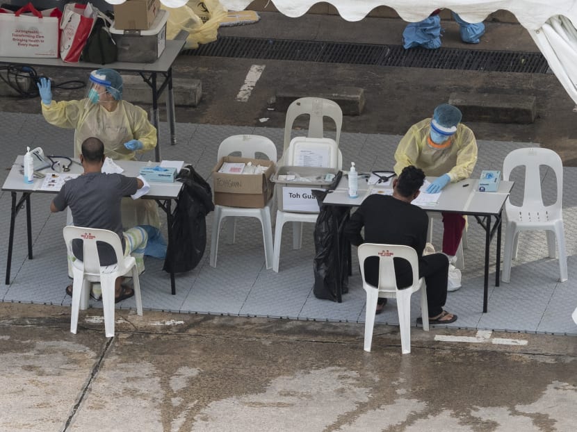 Health workers processing medical documents for migrant workers at Toh Guan Dormitory on April 30. The author says it would be indiscriminate to say that migrant workers were treated as invisible.