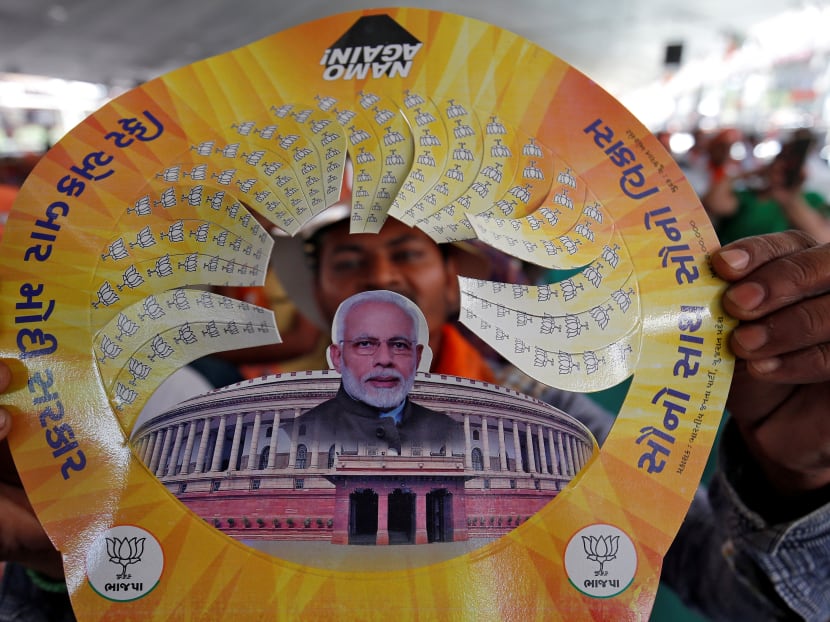 Photo of the day: A supporter of India's Prime Minister Narendra Modi displays a paper cap with images of Modi and Indian Parliament during an election campaign rally in Junagadh, Gujarat, India, April 10, 2019.