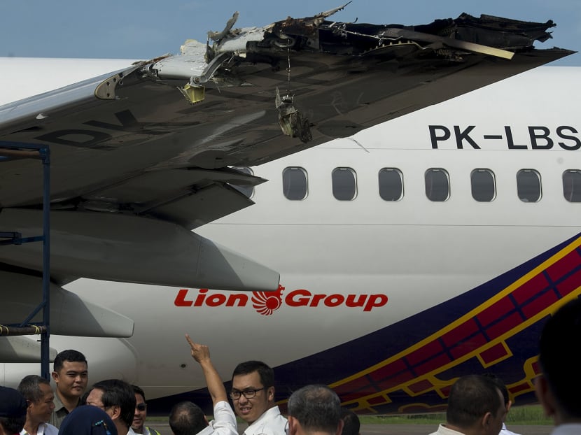 Officials and investigators from the Ministry of Transportation examine the wing of a Batik Air Boeing 737-800, which was damaged in a collision yesterday with another plane while on the runway at Halim Airport in Jakarta, Indonesia on April 5, 2016. Photo: Antara Foto via Reuters
