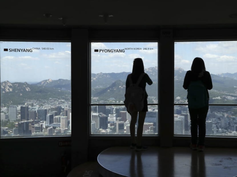Visitors tour near the window with a sign "Pyongyang" at the N Seoul Tower in Seoul, South Korea. AP file photo