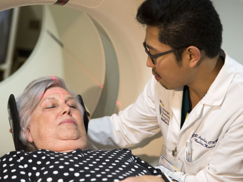 In this photo taken May 19, 2015, Ms Judith Chase Gilbert, of Arlington, Virginia., is loaded into a PET scanner by Nuclear Medicine Technologist JR Aguilar at Georgetown University Hospital in Washington. Photo: AP