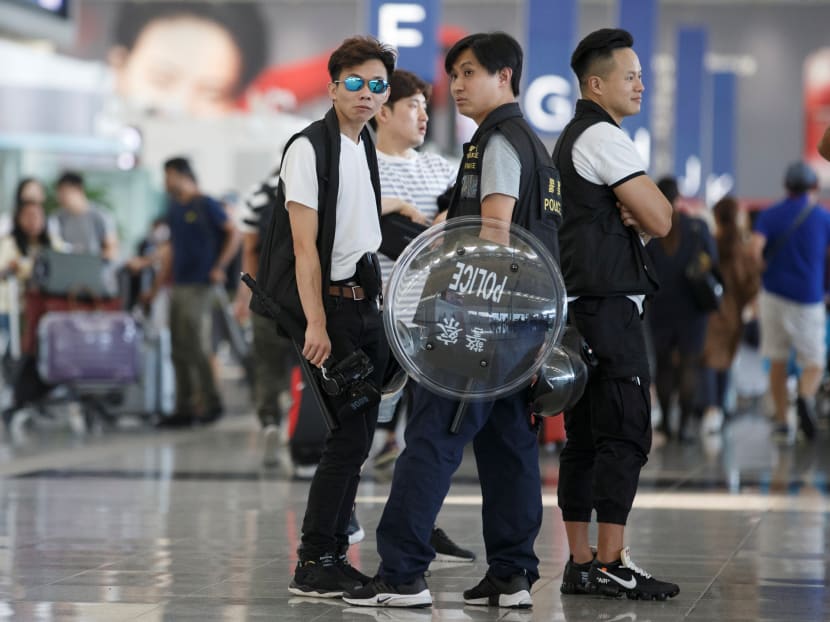 Police patrol the departure hall of the airport in Hong Kong on Wednesday (Aug 14).