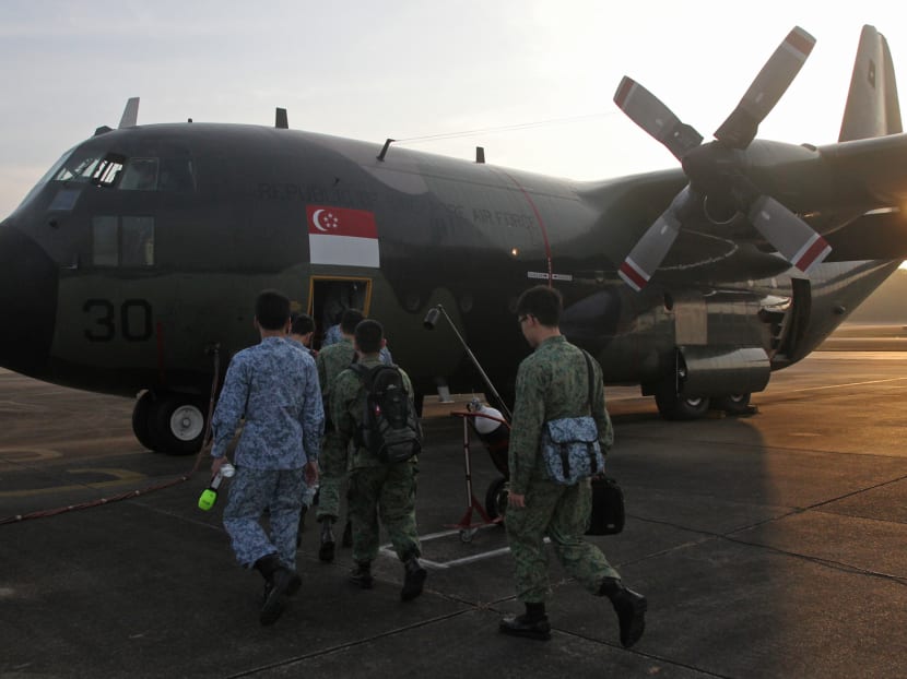 Servicemen boarding the C-130 for a search-and-locate mission to locate the missing Malaysian Airlines plane MH370 on March 11, 2014. Photo: Ooi Boon Keong