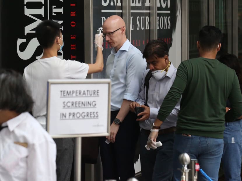 People getting their temperature checked before entering their office building. An official from the Ministry of Health said that the Covid-19 coronavirus has affected a large number of people across the globe and caused many deaths, so its impact cannot be trivialised.