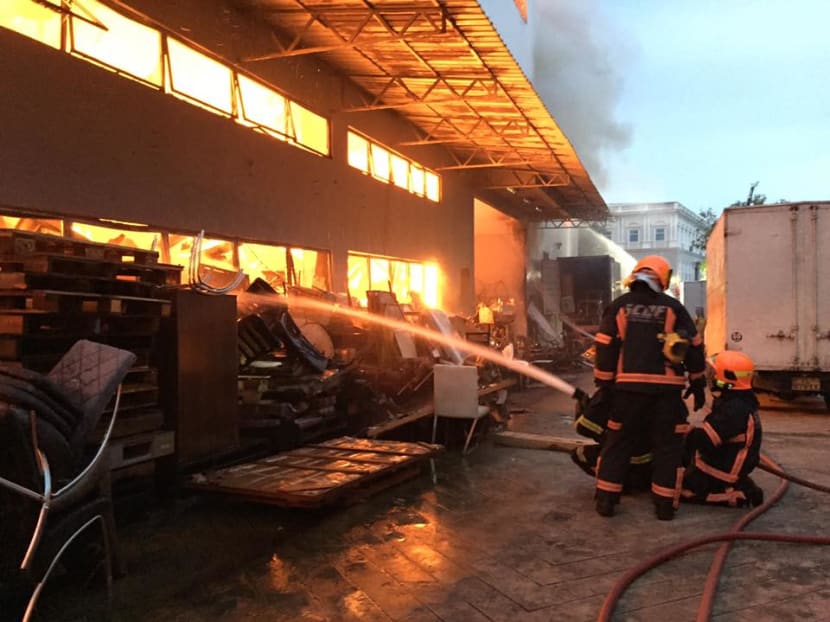 Firefighters putting out the fire that gutted a Sungei Kadut warehouse. Photo: The Singapore Civil Defence Force