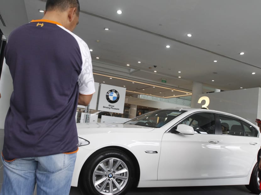Buyers shopping for cars at a Leng Kee Road showroom. Photo: Ernest Chua