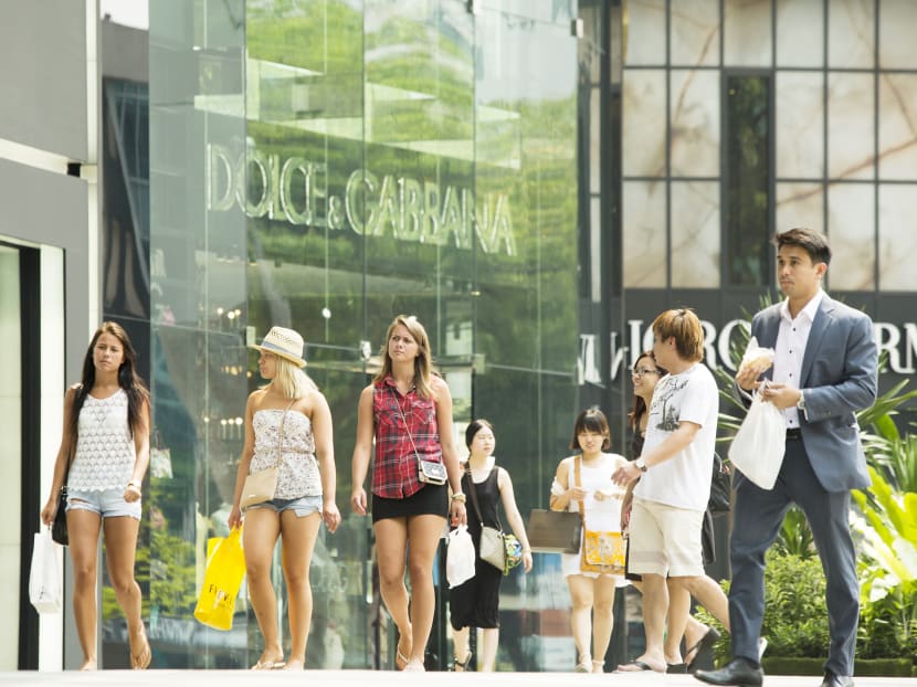 Shoppers walk by a Dolce & Gabbana store on Orchard Road. Bloomberg file photo