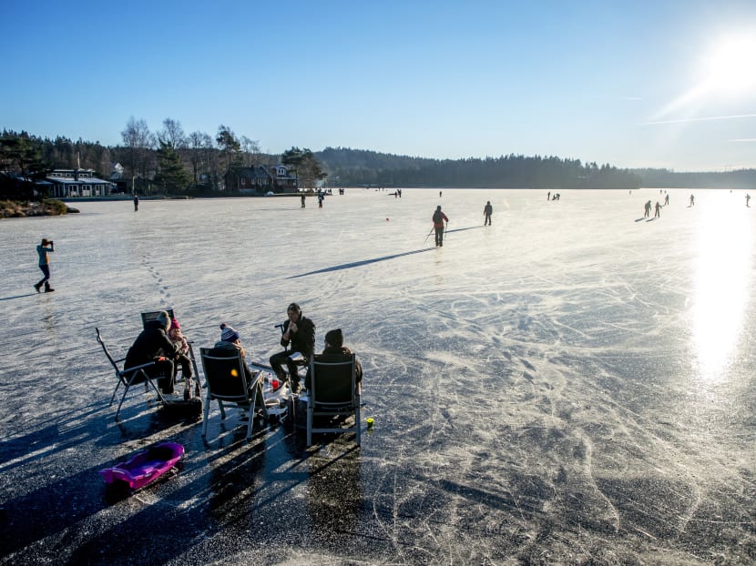 People picnic after a tour of nordic ice skating on the frozen lake of Stora Stamsjon, in Lerum, Sweden on Jan 16, 2021.
