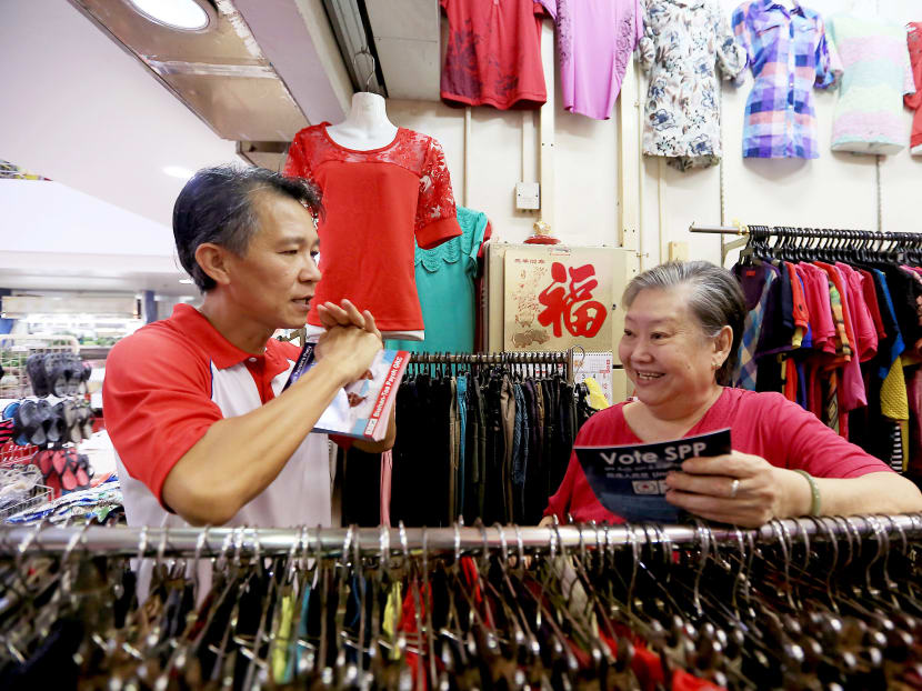 SPP Bishan-Toa Payoh candidate Law Kim Hwee with a resident at Shunfu Market yesterday. His team plans to carry out two walkabouts a day. Photo: Koh Mui Fong/TODAY