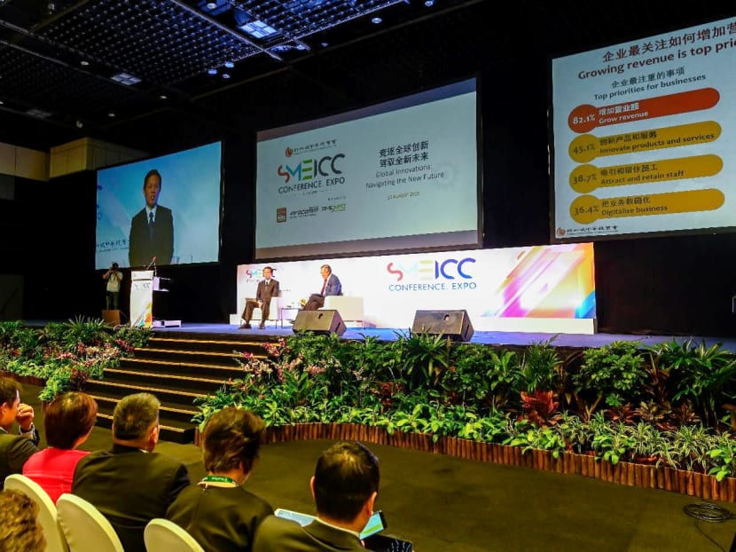 Trade and Industry Minister Chan Chun Sing (on stage, left) speaking at the 21st Annual SME Conference organised by the Singapore Chinese Chamber of Commerce and Industry.