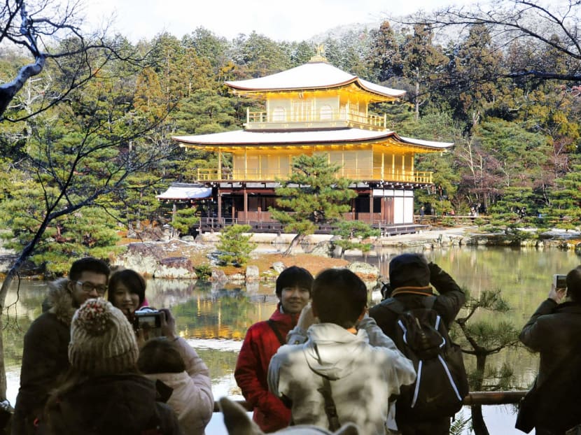 Tourists at Kinkakuji Temple in Kyoto. The government plans to improve access to cultural attractions, among other measures, to draw 40 million tourists to Japan in 2020, when it hosts the Olympics. Photo: Kyodo