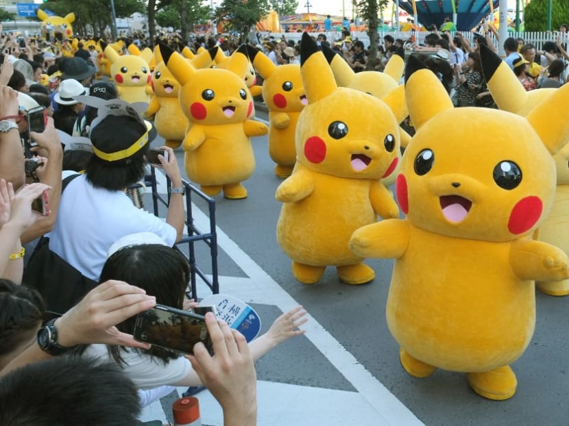 In this file photo taken on August 7, 2016 performers dressed as Pikachu, the popular animation Pokemon series character, perform in the Pikachu parade in Yokohama.