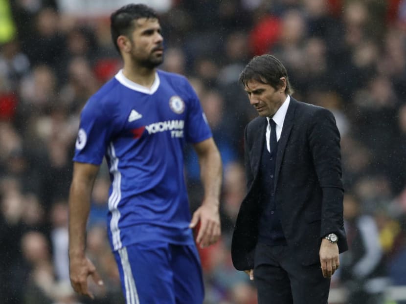 Antonio Conte (right) and Chelsea striker Diego Costa looking dejected after the Blues' 0-2 loss to Manchester United at Old Trafford on Sunday. Photo:Reuters