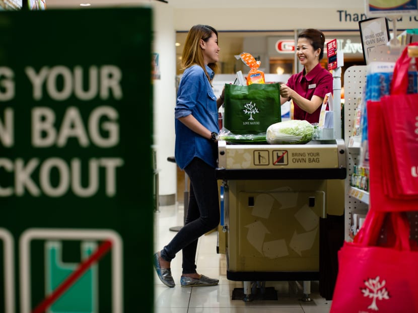 A photograph of an NTUC cashier checkout point during the Bring Your Own Bag, FairPrice Green Rewards Scheme. Photo: NTUC FairPrice Co-operative Ltd