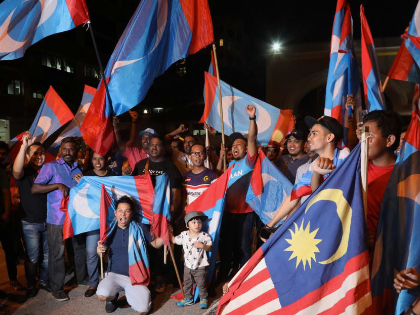 Malaysians celebrating Pakatan Harapan's historic victory on May 9. The author says that for several years now, the scandal-ridden previous government had presented citizens with a unique problem – that of Travelling While Malaysian.